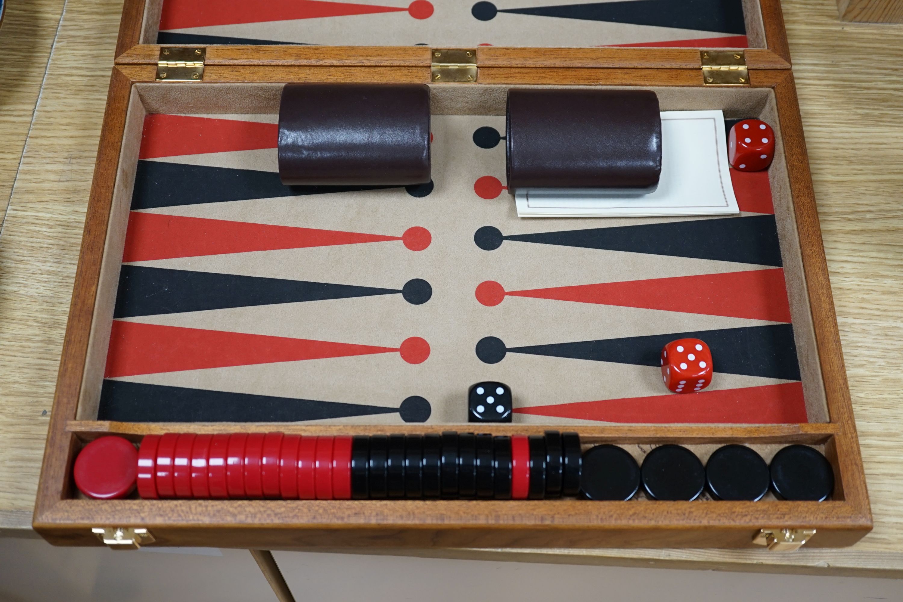 A cased Backgammon set and a chess set with chess-board top and drawers for chess pieces, chess box 35.5 cms x 35.5 cms.